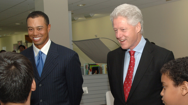 Bill Clinton and Tiger Woods smiling