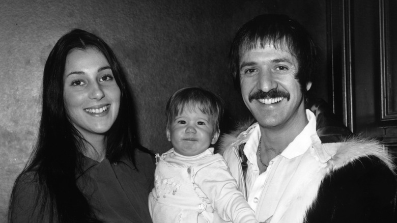 Cher and husband Sonny Bono post for photos with their kid