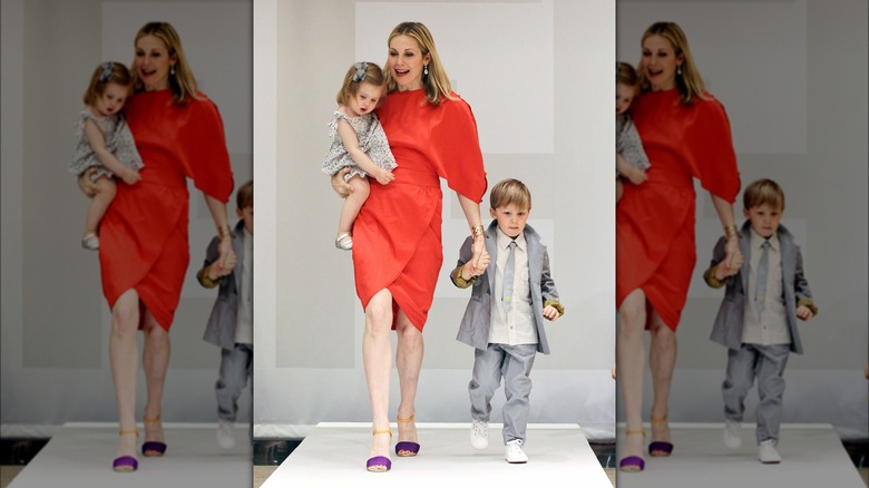 Kelly Rutherford walking a catwalk with her two children