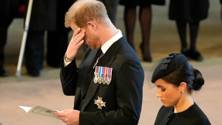 Prince Harry, Duke of Sussex and Meghan, Duchess of Sussex pay their respects in The Palace of Westminster after the procession for the Lying-in State of Queen Elizabeth II in London (2022)