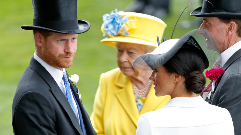 Prince Harry, Duke of Sussex, Meghan, Duchess of Sussex and Queen Elizabeth II attend day 1 of Royal Ascot at Ascot Racecourse in Ascot, England (2018)