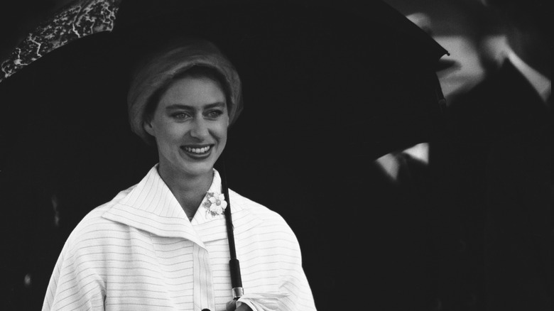 Princess Margaret holding umbrella smiling