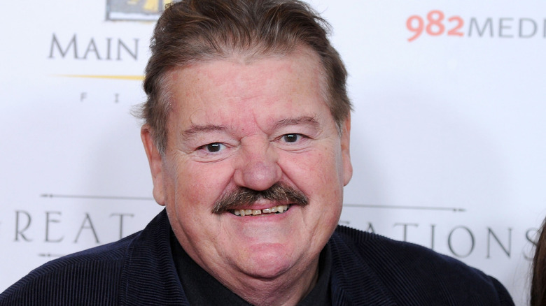 Robbie Coltrane smiling with moustache 