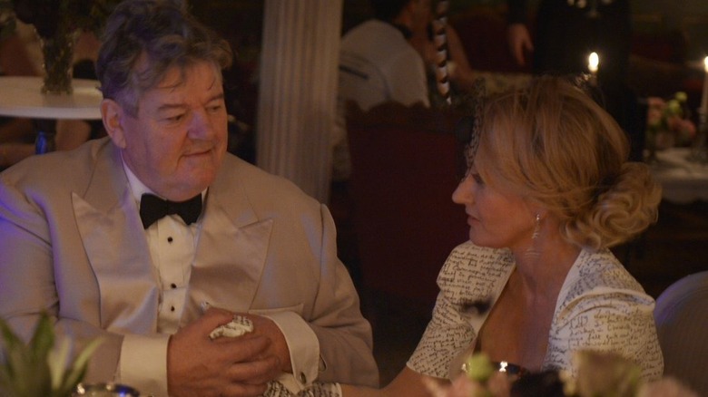 Robbie Coltrane sitting with JK Rowling 