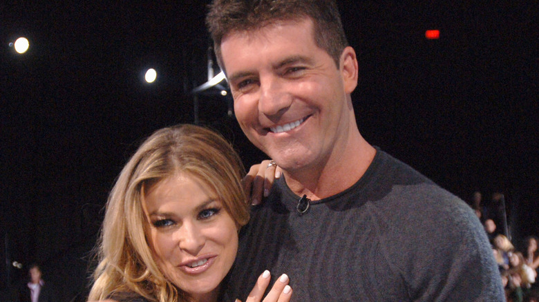 Carmen Electra hugging Simon Cowell