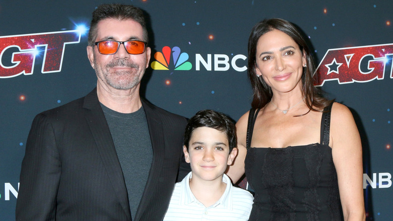 Simon Cowell with Lauren Silverman and their son posing