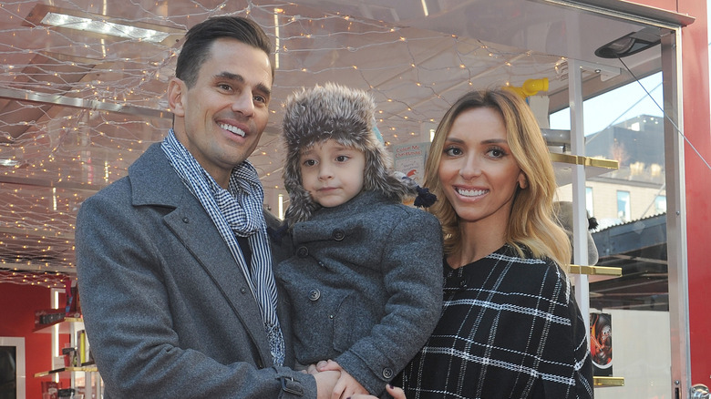 Giuliana, Duke and Bill Rancic posing for photos