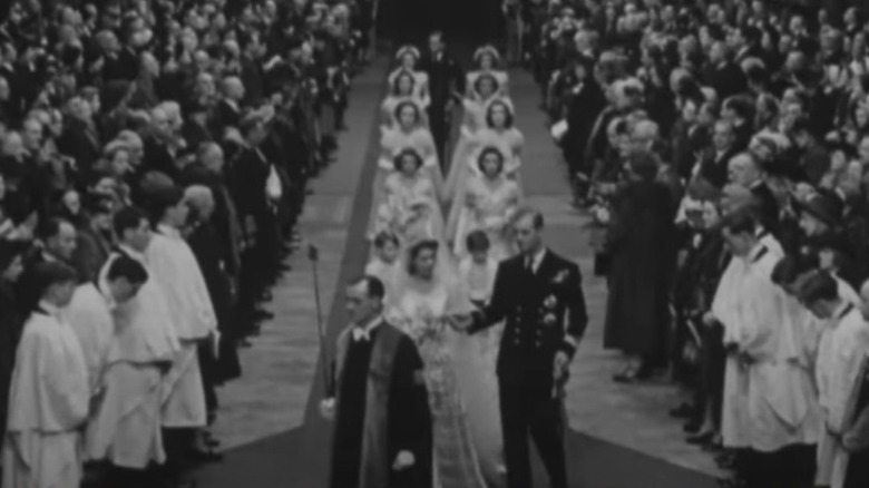 Queen Elizabeth and Prince Philip walking down the aisle