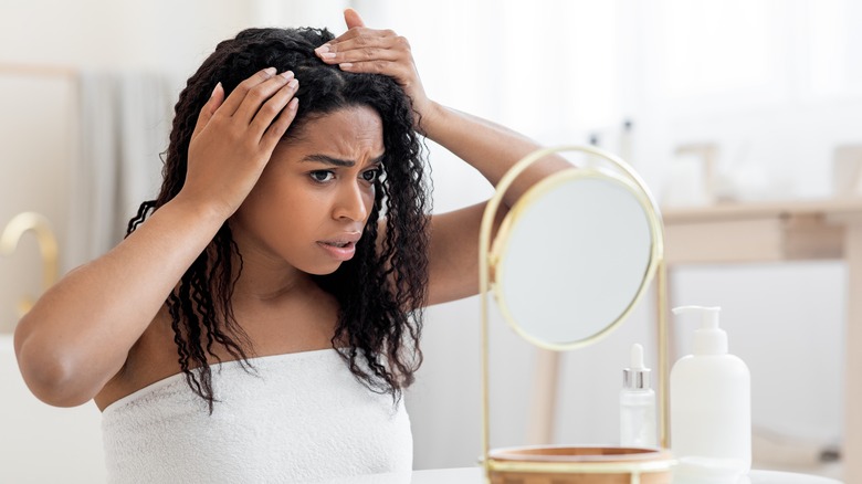 woman examining her scalp