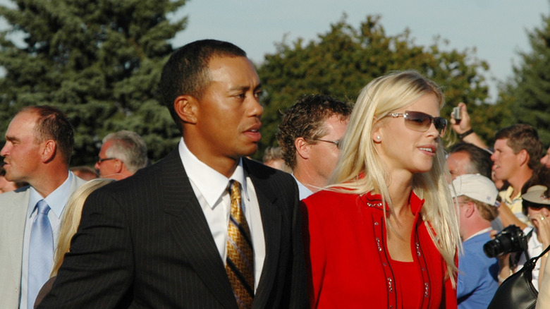 Tiger Woods and former wife Elin Nordegren walking through a crowd