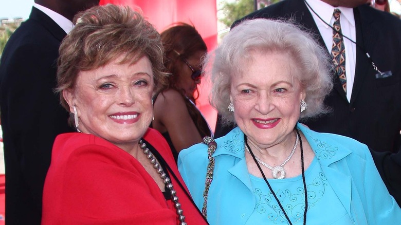 Rue McClanahan and Betty White smiling together at an event