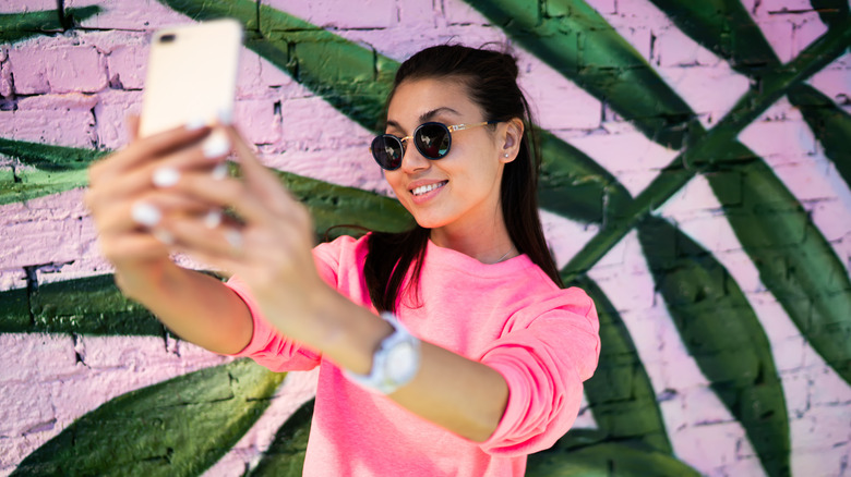 woman taking selfie with phone