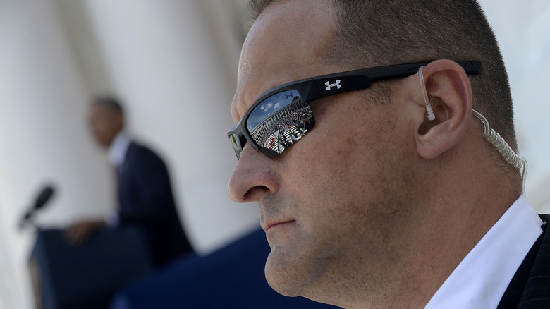 Secret Service agent watches as President Obama speaks