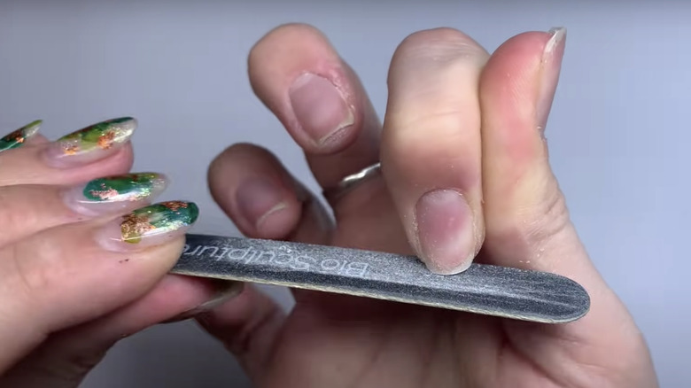 Woman filing her nails