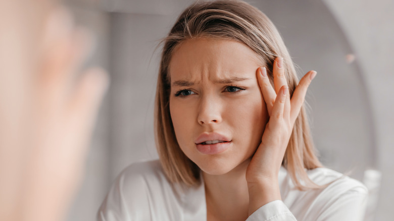 confused woman touching face