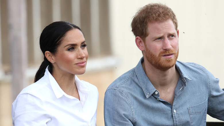 Meghan Markle and Prince Harry listening during an interview