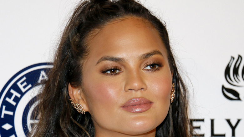 Chrissy Teigen poses at an event