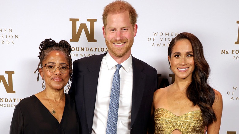 Doria Ragland posing with Harry and Meghan 