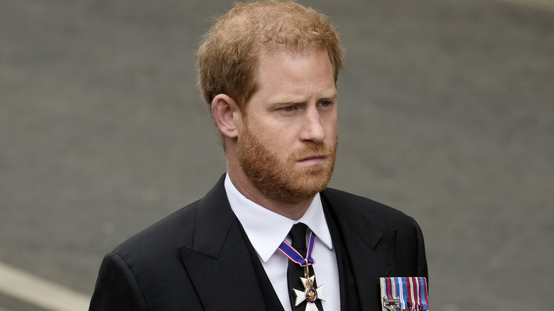 Prince Harry side profile in suit and military medals