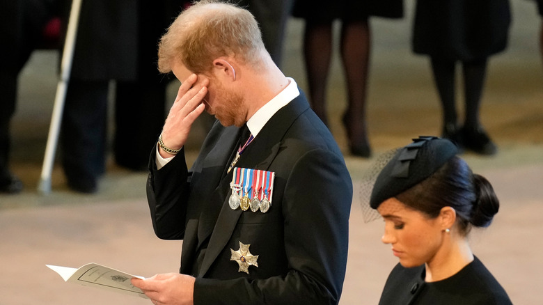 Prince Harry covering his eyes