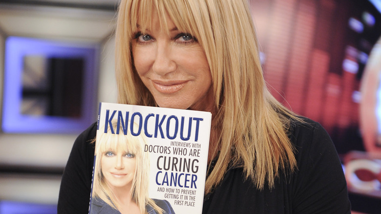 Suzanne Somers holding her book