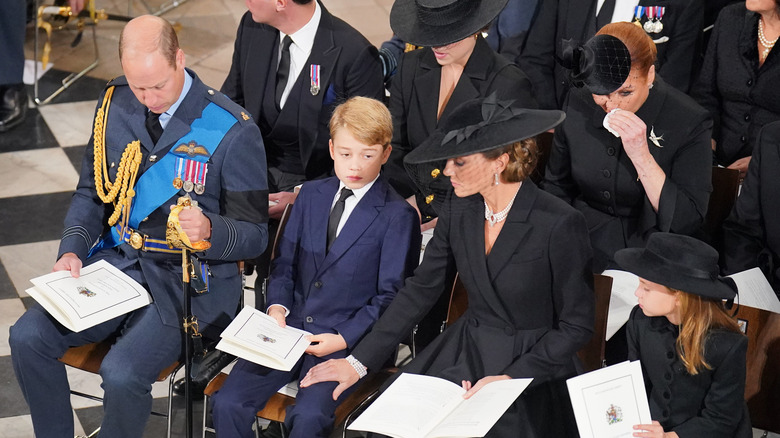 Kate Middleton placing her hand on Prince George's knee