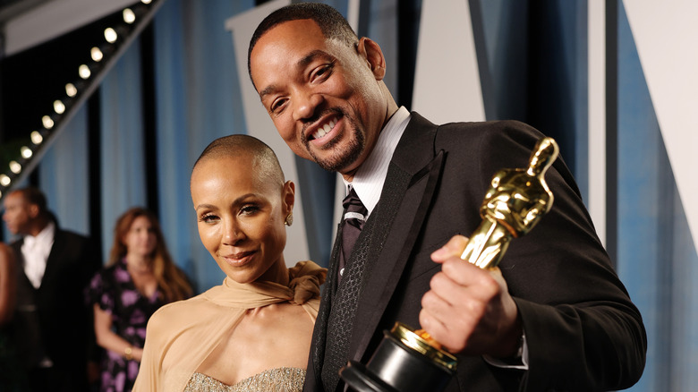 Will Smith and Jada Pinkett Smith pose at an Oscars event