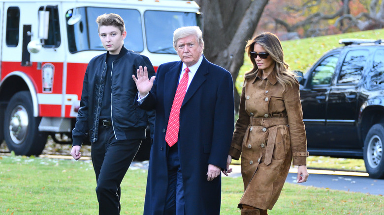 Barron Trump walking with his parents