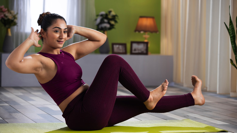 Woman doing seated abdominal twist