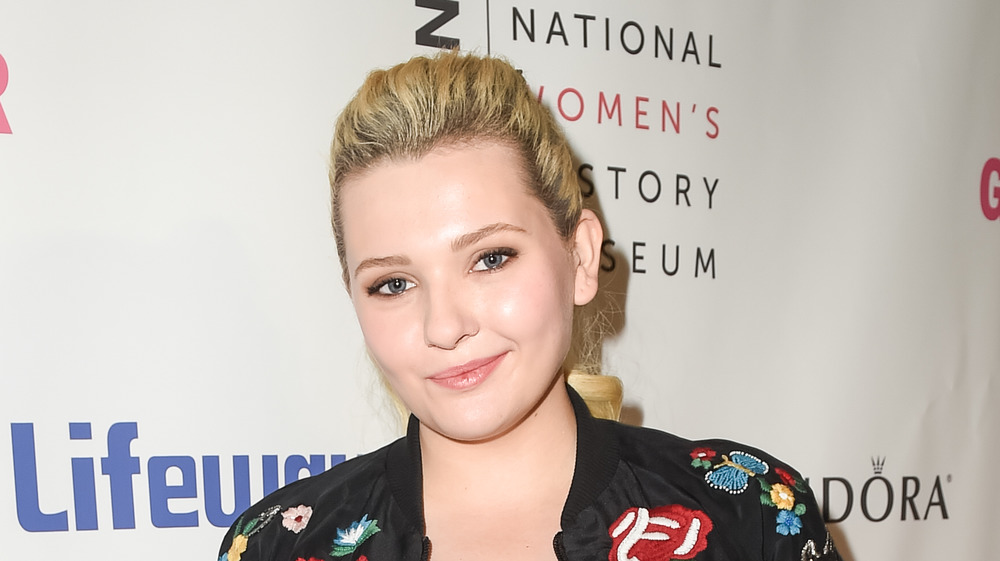 Abigail Breslin smiling at event