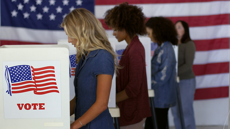 women at voting booths