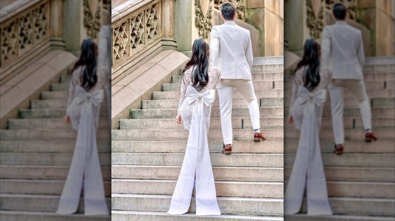 Bride and groom walk up stairs