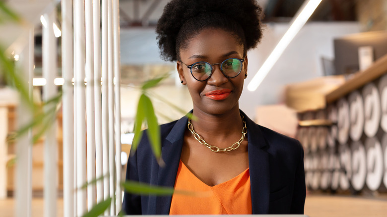 A woman wearing glasses at her laptop