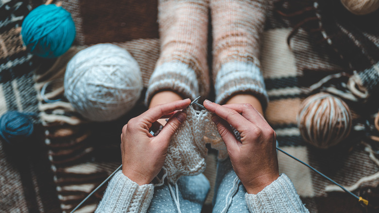 Person knitting in cozy socks