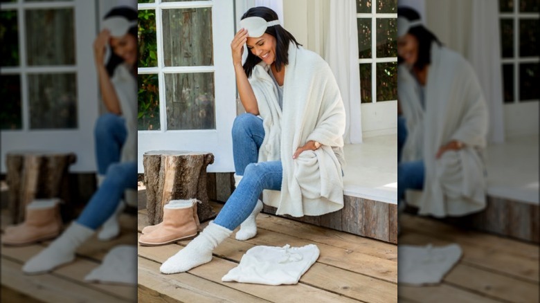 Model wearing cozy white wrap and eye mask