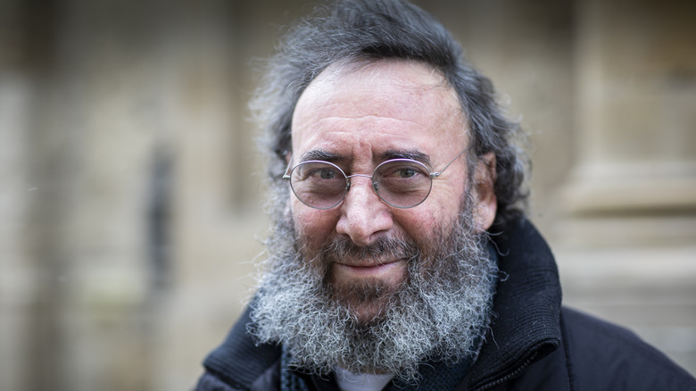 Antony Sher wearing glasses, smiling