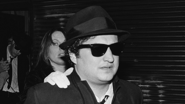 John Belushi in glasses and hat 