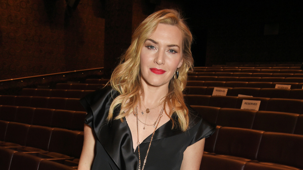 Kate Winslet standing in a theater