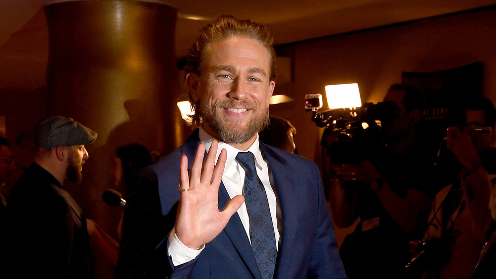 Charlie Hunnam waving