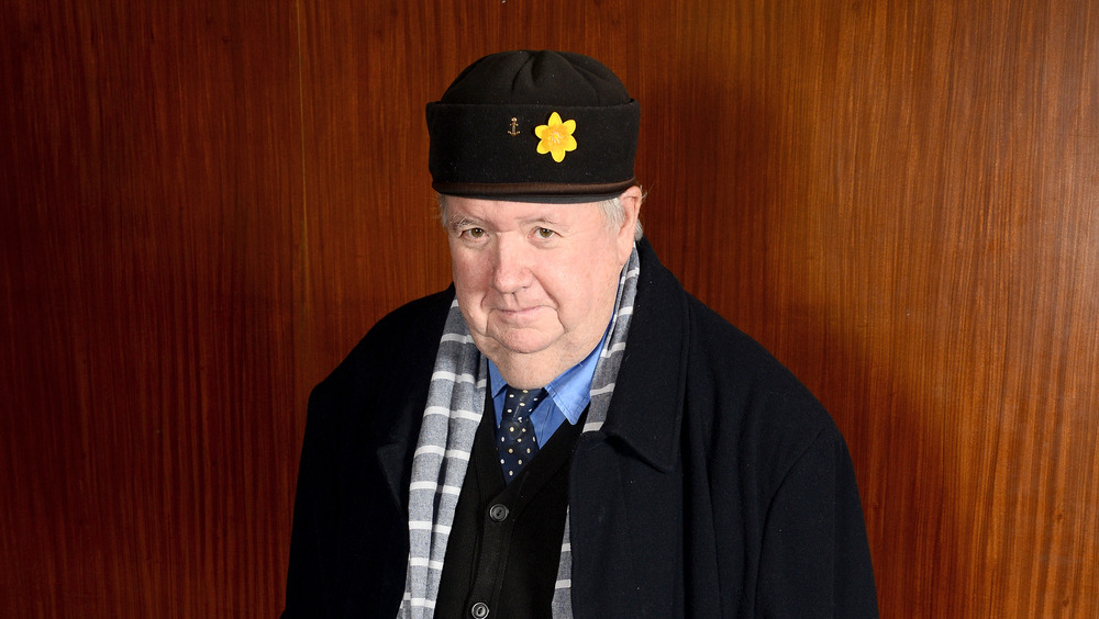 Ian McNeice wearing a hat