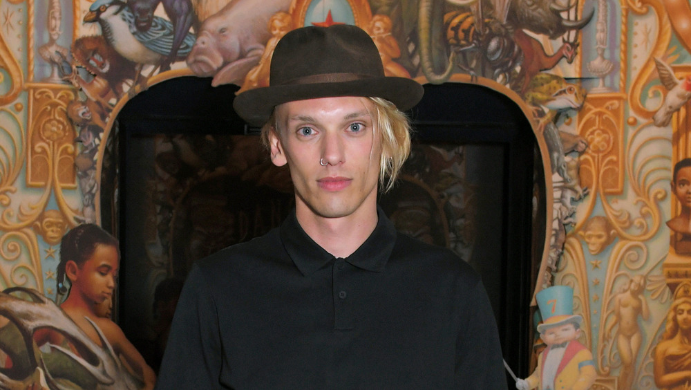 Jamie Campbell Bower wearing a hat