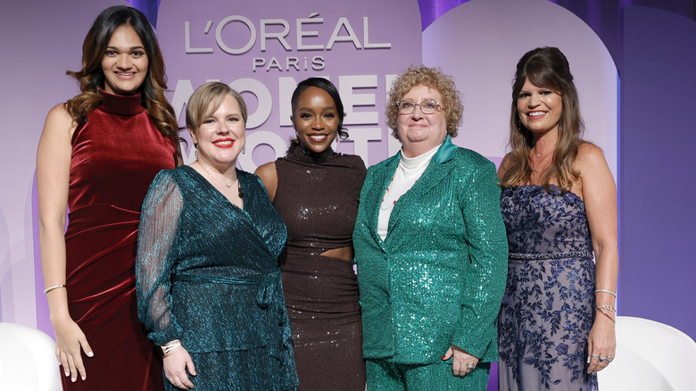 Aja Naomi King posing with 2022 L'Oréal Paris Women of Worth honorees