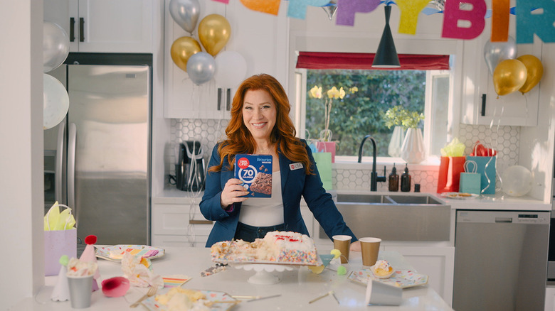 Lisa Ann Walter in kitchen holding Fiber One