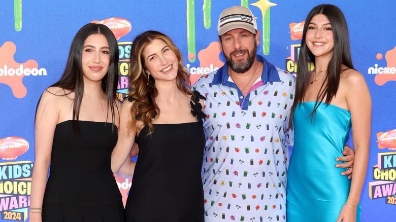 Adam Sandler posing with wife and kids