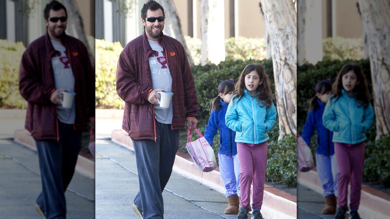 Adam Sandler walking with his young daughters