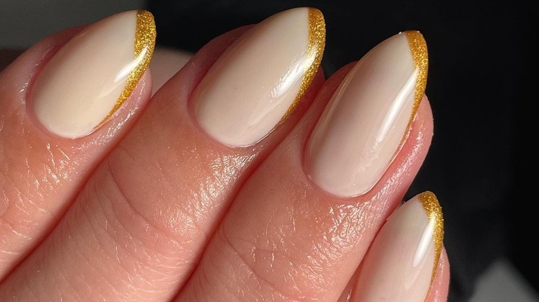 Warm toned nails with gold tips 