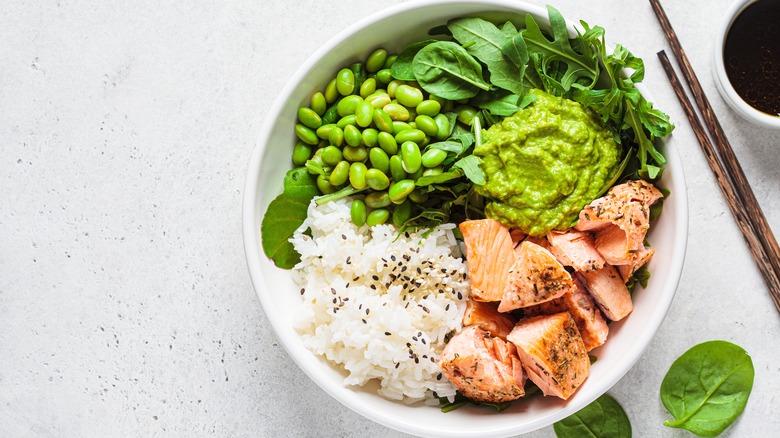 Healthy bowl of salmon with rice and greens