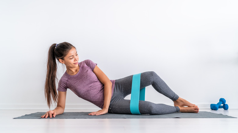 Woman doing clamshells with resistance band