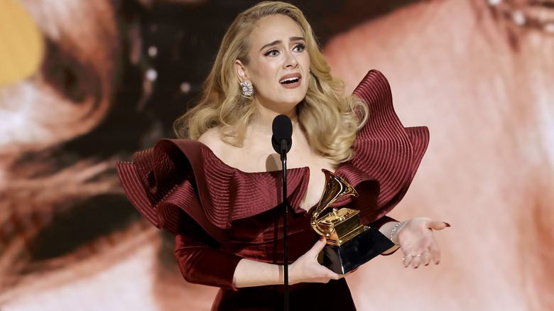 Adele holding a Grammy Award