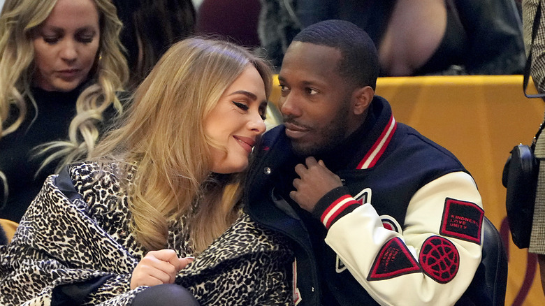 Adele and Rich Paul leaning in to each other